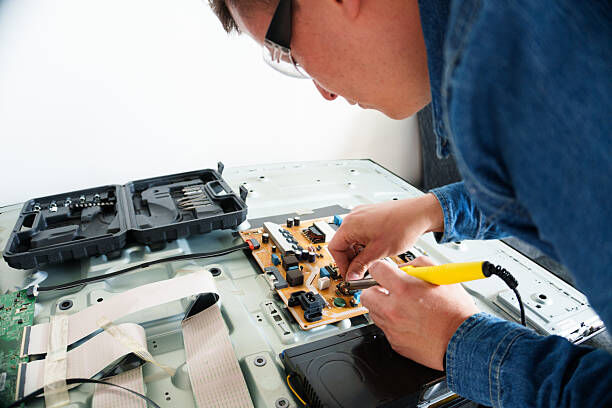 Technician repairing a television